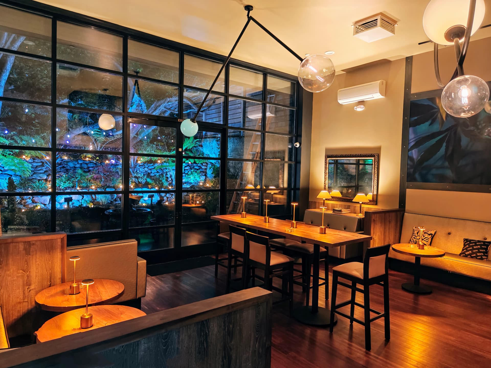 The lounge at Russian Hill Cannabis Club with vinyl wall, murals and city-view screens